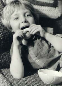 Benjamin eating a cheese puff.